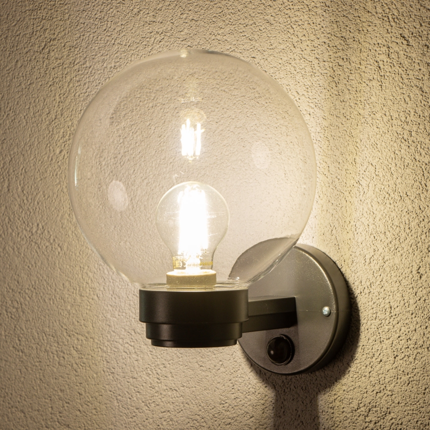 BRILAGI - Utomhusvägglampa med rörelsesensor HARBOR 1xE27/40W/230V IP33 svart/klarglas