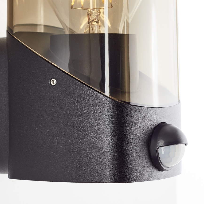 Brilliant - Utomhus vägglampa med sensor MINOU 1xE27/10W/230V IP44 svart/rökig