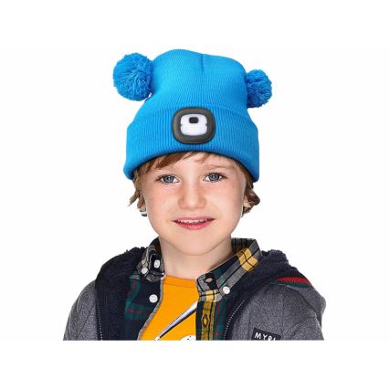 Extol - Mössa med pannlampa och USB-uppladdningsbart batteri 250 mAh, blå med pom-poms, barnstorlek