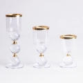 Set om 3 ljusstakar i guld och klart glas
